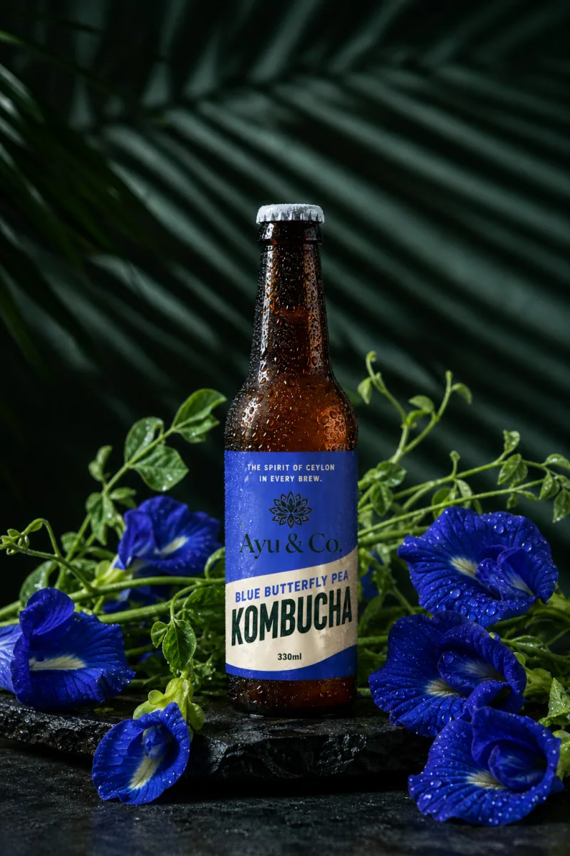 Ayu & Co. Blue Butterfly Pea Kombucha bottle nestled in vivid blue butterfly pea flowers and green vines